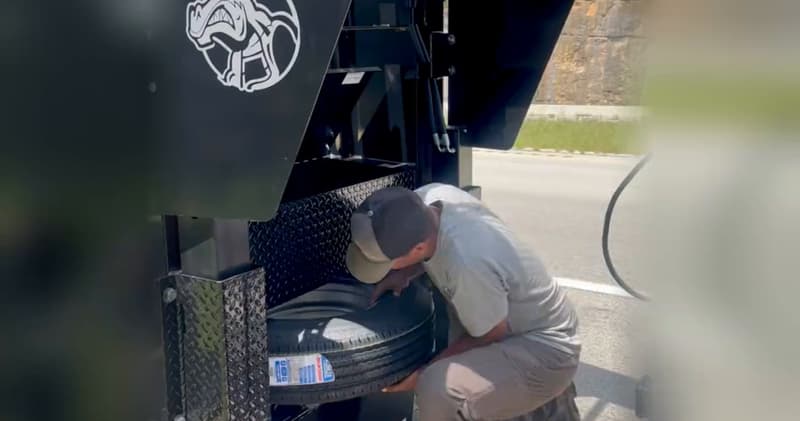 Commander series gooseneck trailer: a full-size spare tire being taken out of the gooseneck neck compartment, then the Commander neck toolbox and its racked chain binders